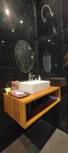a bathroom with a white sink and a mirror at Angad Farms in Kharar +7 photos