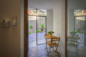 a door leading to a patio with a table and chairs at La Colombaia Bed and Rooms in Belvedere Marittimo
