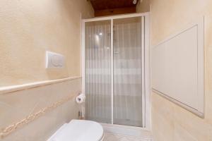 a bathroom with a toilet and a glass shower at Casa Dolce Casa Al Castello in Pozzolengo +13 photos