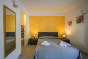 a bedroom with a bed with two towels on it at La Colombaia Bed and Rooms in Belvedere Marittimo