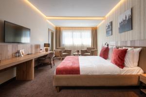 a hotel room with a bed and a desk at Hotel Le 830 Namur in Namur