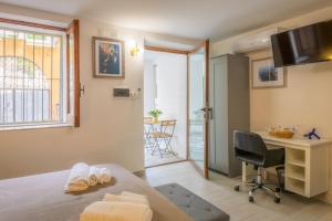 a room with a bed and a desk and a chair at La Colombaia Bed and Rooms in Belvedere Marittimo