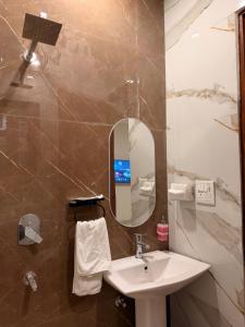 a bathroom with a sink and a mirror at Urban Nest By Jassi in Kharar