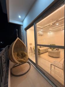 a room with a hanging chair and a living room at Urban Nest By Jassi in Kharar
