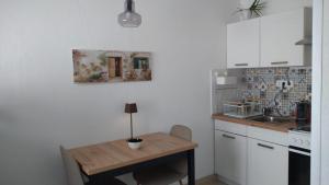 a kitchen with a wooden table and a sink at Studio apartman Marija 2 in Bol +8 photos