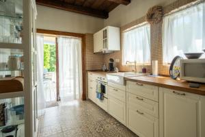 a kitchen with white cabinets and a sink at Kouzelný domeček in Ostrava