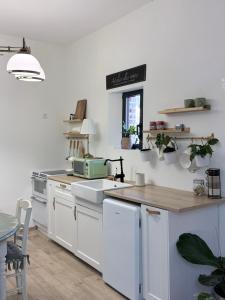 a kitchen with white cabinets and a counter top at Chez Joséphine in Gerville