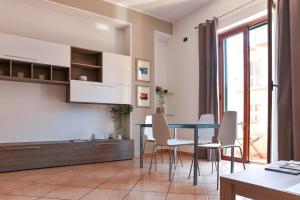 a kitchen and dining room with a table and chairs at La Casa di Birba in Acquedolci