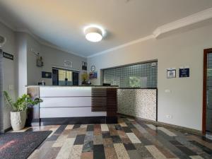 a bathroom with a counter and a tile floor at Hotel Boa Vista by Carlton in Americana