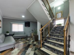 a living room with stairs and a couch at Hotel Boa Vista by Carlton in Americana