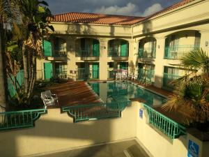 a large building with a swimming pool in front of it at LYFE INN & SUITES by AGA - LAX Airport in Inglewood