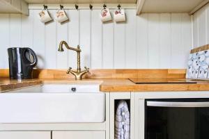 a kitchen with a sink and a counter top at Host & Stay - Shepherds Delight in Alburgh +9 photos