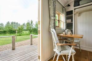 a chair sitting at a table on a porch at Host & Stay - Shepherds Delight in Alburgh