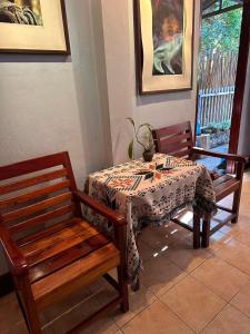 a table and two chairs with a table and a table at 喜悦民宿 Joy in Luang Prabang