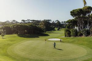 a person is standing on a golf course at Vale Do Lobo Resort in Vale do Lobo +19 photos