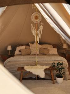 a bedroom with a bed in a tent at Glamping Ty Západy in Stanový