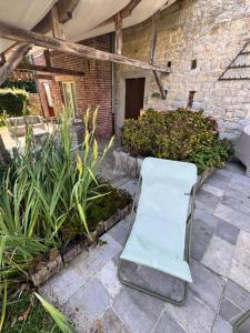 a white chair sitting in the middle of a patio at Le gîte d’Hayen in Sprimont +69 photos