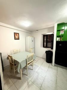 a kitchen with a table and chairs and a refrigerator at Majka Guest House in Kotor +14 photos
