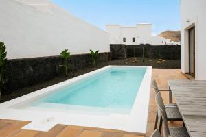 a swimming pool on the roof of a house at Villa Volcano by CasasBlancas in Yaiza +26 photos