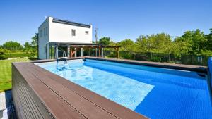 a swimming pool with a house in the background at Villa Una by Villas Guide in Gornji Kneginec
