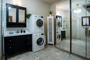 a bathroom with two washing machines and a sink at Kouzelný domeček in Ostrava +19 photos