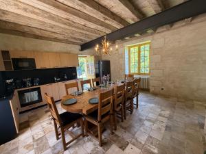 a large dining room with a table and chairs at Gîte du Château des Brétignolles - Patrimoine, Piscine & Nature - Près de Chinon in Anché