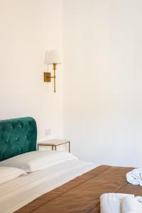 a bedroom with a bed and a cross on the wall at B&B Faraglione in Lipari