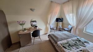 a bedroom with a bed and a desk with a mirror at Dimana in Chernomorets