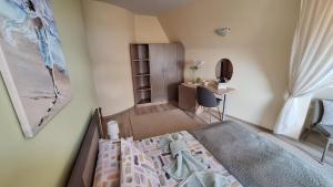 a small bedroom with a bed and a desk at Dimana in Chernomorets +27 photos
