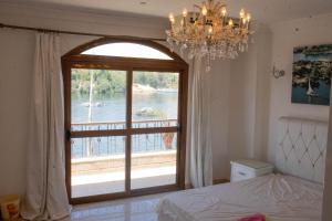 a bedroom with a large window with a view of the water at Island House in Jazīrat Aswān +52 photos