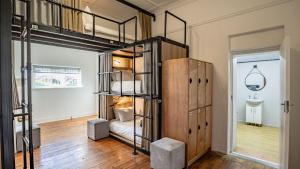 a room with two bunk beds and a hallway at Adamastor Backpackers in Muizenberg +52 photos