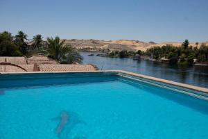 a swimming pool with a view of a river at Island House in Jazīrat Aswān