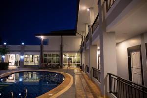 a swimming pool in the middle of a building at night at The one residence in Ban Nong Phak Nam