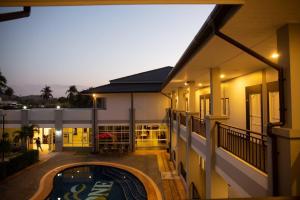 an apartment building with a swimming pool at night at The one residence in Ban Nong Phak Nam +3 photos