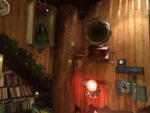 a room with a wooden wall with a tv on the wall at Feggaropetra Inn Magic Mountain House in Palaios Panteleimonas