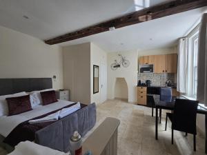 a bedroom with a large bed and a kitchen at White Hart Hotel in St. Albans