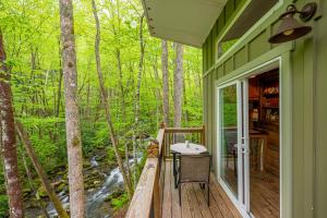 a green house with a deck with a table at The Owl's Perch in Robbinsville +40 photos