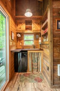 an interior view of a kitchen in a tiny house at The Owl's Perch in Robbinsville