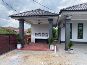 a patio of a house with aestead at Suria guesthouse in Kampung Raja