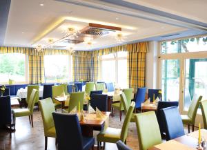 a dining room with tables and chairs and windows at Hocheck in Altmünster