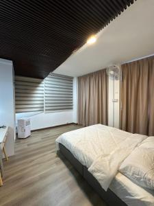 a bedroom with a large bed with a black ceiling at RY Homestay in Tawau