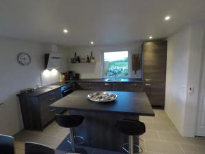 a kitchen with a island with a bowl on it at Top Modern Holiday Home 100 M From The Baltic Sea in Nordborg