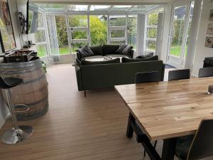 a living room with a couch and a wooden table at Top Modern Holiday Home 100 M From The Baltic Sea in Nordborg