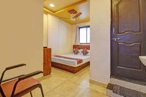 a small bedroom with a bed and a door at Via Kamal Stay Inn in Alandi