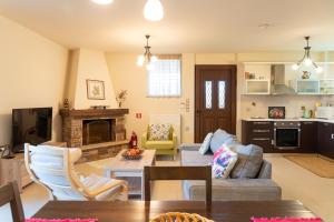 a living room with a couch and a table at Villa Polyxeni Lavender 150m from the sea in Politika