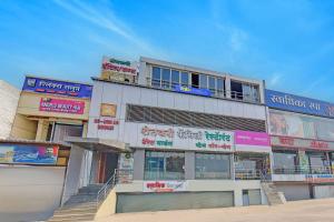 a building with signs on the side of it at Via Kamal Stay Inn in Alandi
