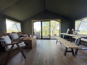 a living room with a couch and a table at Brocklands Farm Glamping in Petersfield