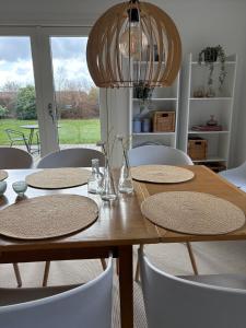 a dining room table with chairs and a large window at Summer House Near The Sea And Good Experiences in Børkop