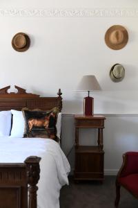 a bedroom with a bed and a lamp and a chair at Château de Fontager in Serves-sur-Rhône