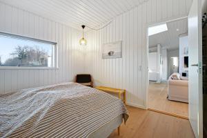 a bedroom with a bed and a living room at New Modern Holiday Home Near The Beach in Aabenraa